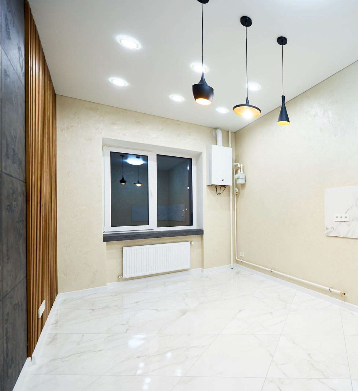 Bright room with large window and heater by 911 Property Services
